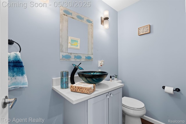 7910 Anchor Bay Dr, Clay, MI 48001 - half bathroom with toilet, vanity, and baseboards