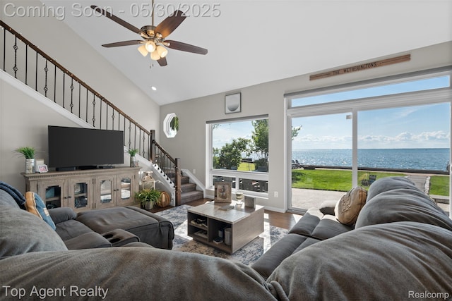7910 Anchor Bay Dr, Clay, MI 48001 - living room with a water view, ceiling fan, wood finished floors, stairway, and high vaulted ceiling