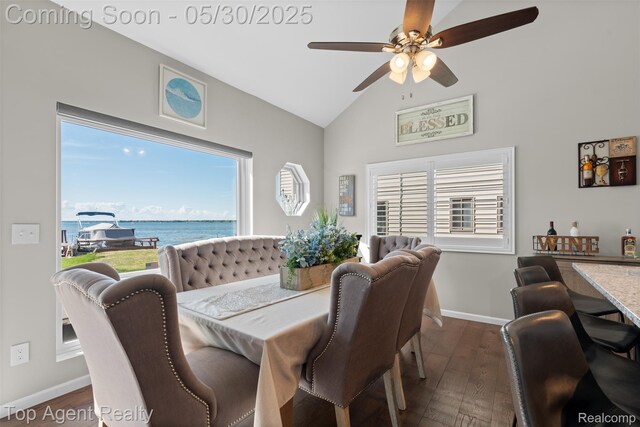 7910 Anchor Bay Dr, Clay, MI 48001 - dining area with a ceiling fan, plenty of natural light, a water view, dark wood-style flooring, and high vaulted ceiling