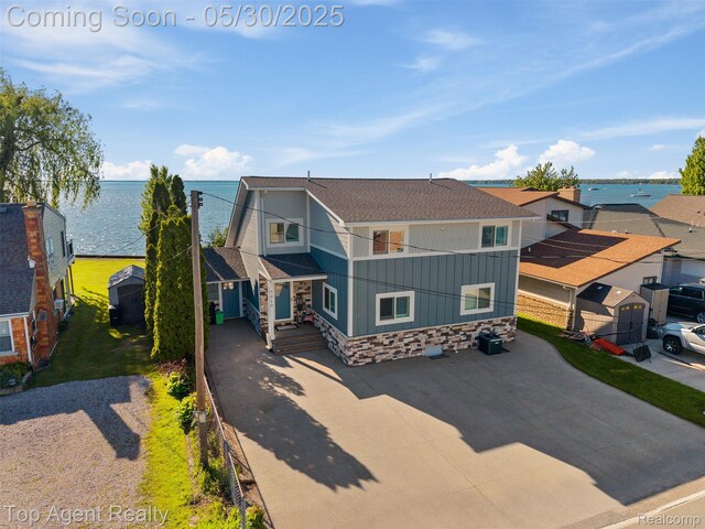 7910 Anchor Bay Dr, Clay, MI 48001 - view of front of home with a water view, board and batten siding, driveway, and a shingled roof