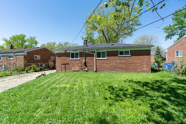 view of front of home featuring brick siding and a chimney