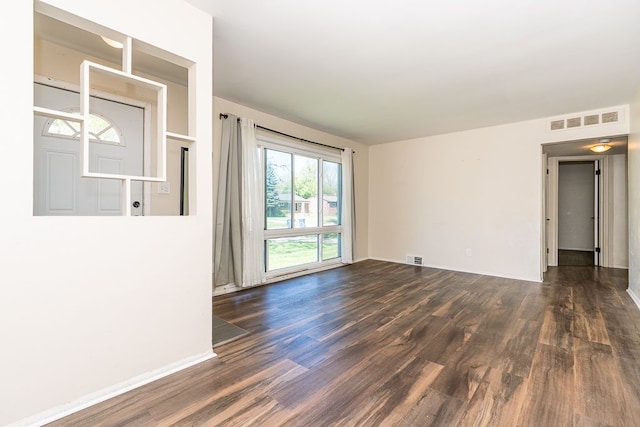 empty room featuring wood finished floors and baseboards