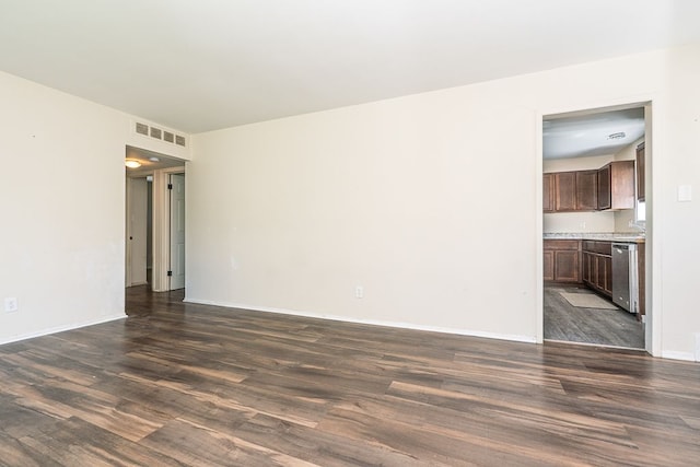 unfurnished living room with dark wood finished floors and baseboards