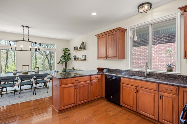 58651 Glacier Club Dr, Washington, MI 48094 - kitchen with dishwasher, a sink, a peninsula, a chandelier, and wood finished floors