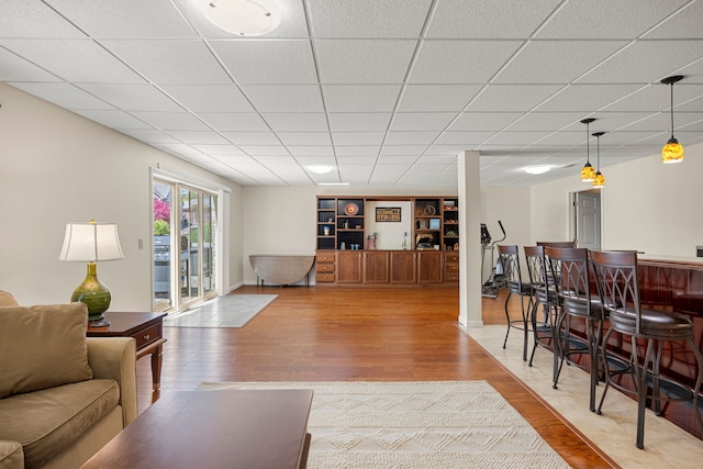 58651 Glacier Club Dr, Washington, MI 48094 - living room featuring wood finished floors, a dry bar, and a paneled ceiling