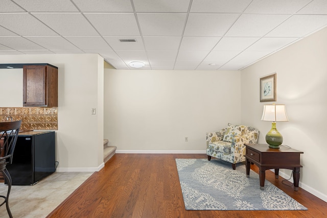 58651 Glacier Club Dr, Washington, MI 48094 - sitting room featuring light wood-style floors, stairs, a drop ceiling, and baseboards