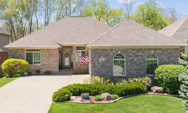 58651 Glacier Club Dr, Washington, MI 48094 - view of front of house featuring brick siding, roof with shingles, a front lawn, and driveway
