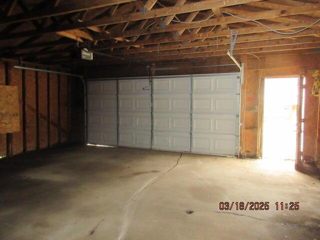 34637 76th St, Covert, MI 49043 - garage featuring a garage door opener