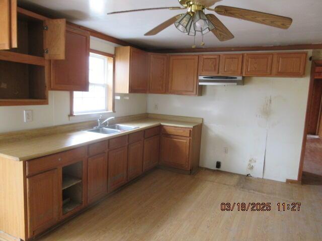 34637 76th St, Covert, MI 49043 - kitchen featuring a sink, brown cabinetry, ceiling fan, and light wood-style flooring