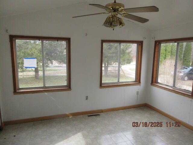 34637 76th St, Covert, MI 49043 - spare room with vaulted ceiling, healthy amount of natural light, a ceiling fan, and baseboards