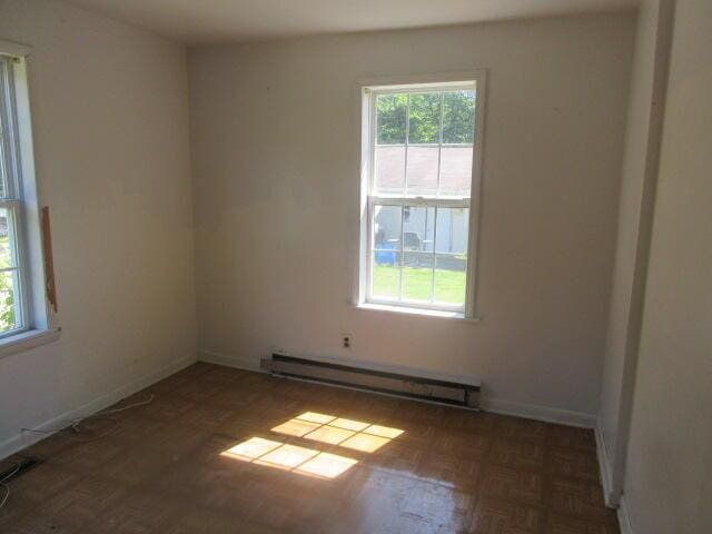 34637 76th St, Covert, MI 49043 - spare room featuring a baseboard radiator and plenty of natural light