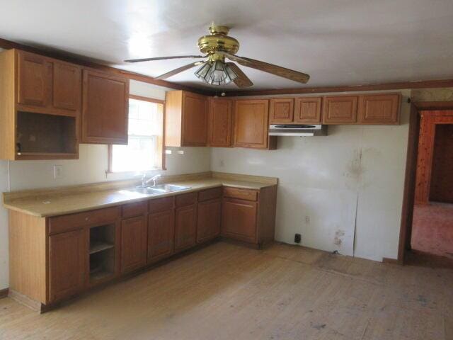 34637 76th St, Covert, MI 49043 - kitchen with light wood-style floors, under cabinet range hood, brown cabinetry, and ceiling fan