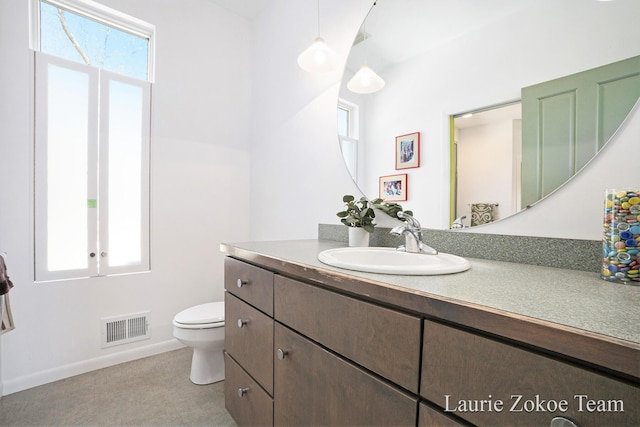 12250 Knoper Ct, Allendale, MI 49401 - bathroom featuring vanity, toilet, and baseboards