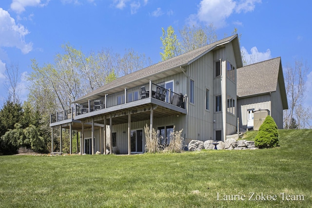 12250 Knoper Ct, Allendale, MI 49401 - back of property with a shingled roof, a lawn, and a wooden deck