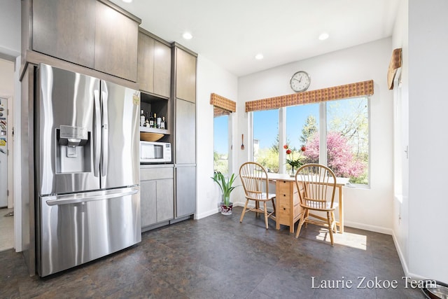 12250 Knoper Ct, Allendale, MI 49401 - kitchen with stainless steel refrigerator with ice dispenser, white microwave, baseboards, and recessed lighting