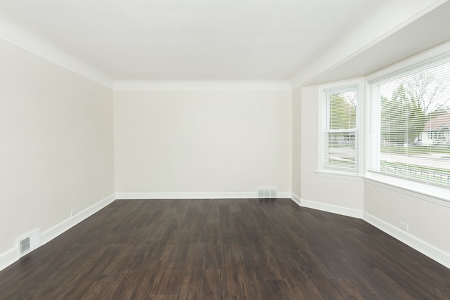 spare room with dark wood-style floors and baseboards