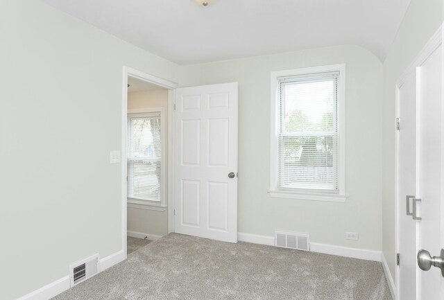 unfurnished bedroom with carpet floors and baseboards