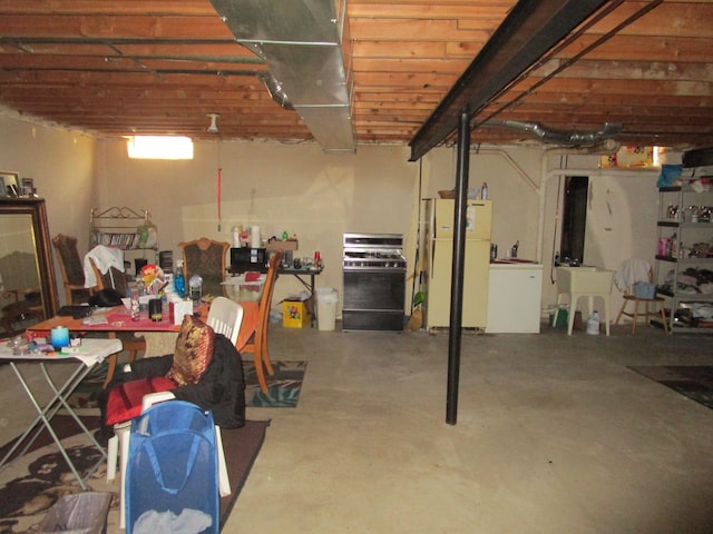 29100 Sunnydale St, Livonia, MI 48154 - below grade area featuring freestanding refrigerator, washer / dryer, and a sink