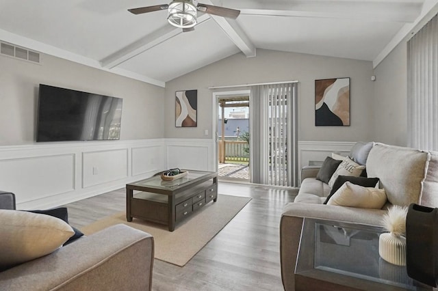 48775 Windmill Cir W, Macomb, MI 48044 - living room featuring ceiling fan, wood finished floors, a decorative wall, and wainscoting