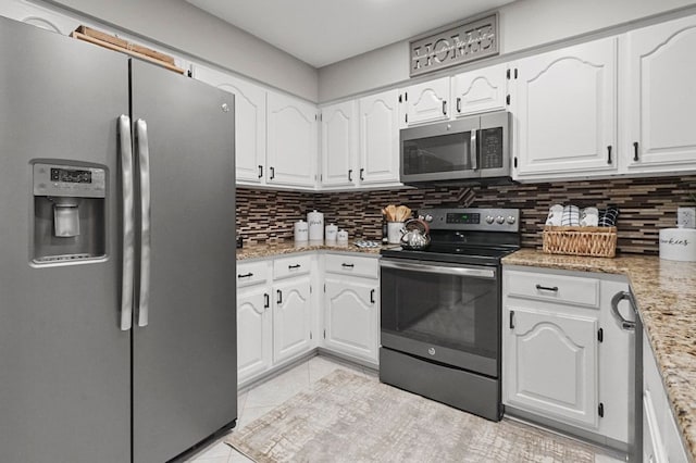 48775 Windmill Cir W, Macomb, MI 48044 - kitchen with appliances with stainless steel finishes, backsplash, white cabinetry, light tile patterned floors, and light stone countertops