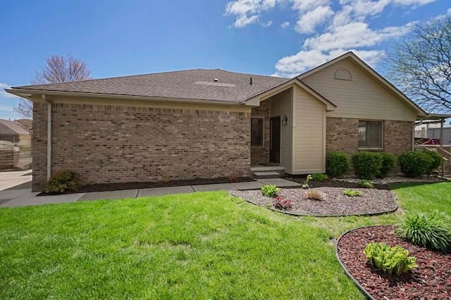 48775 Windmill Cir W, Macomb, MI 48044 - view of front of house with brick siding, a front yard, and a shingled roof