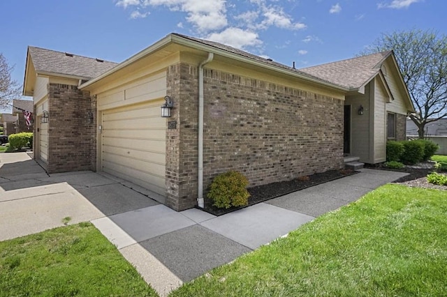 48775 Windmill Cir W, Macomb, MI 48044 - view of property exterior featuring brick siding, a garage, concrete driveway, a lawn, and a shingled roof