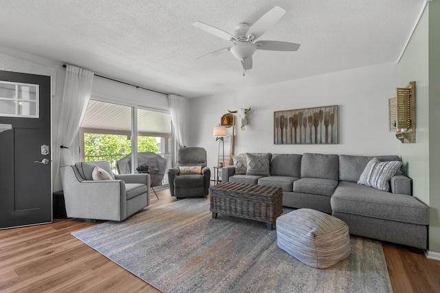 4150 Ridge Rd Unit 21, Stevensville, MI 49127 - living area with wood finished floors, a ceiling fan, and a textured ceiling