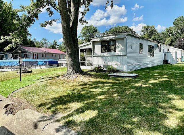 481 Maple Ln, Coldwater, MI 49036 - manufactured / mobile home featuring a front yard and a sunroom