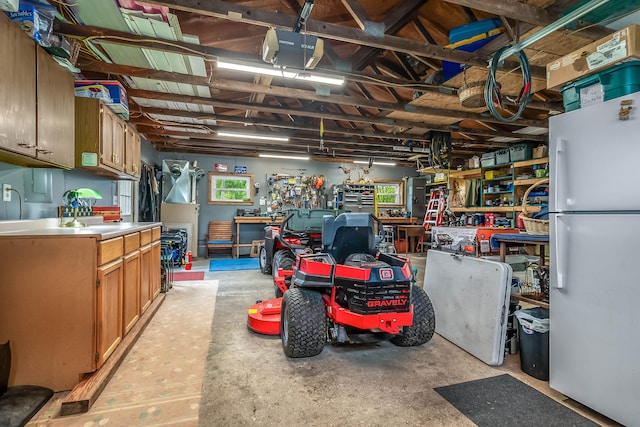 465 Ridge Rd, Quincy, MI 49082 - garage featuring freestanding refrigerator and a workshop area