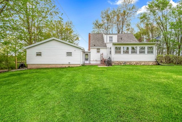 465 Ridge Rd, Quincy, MI 49082 - back of house with a lawn, roof with shingles, and a patio area