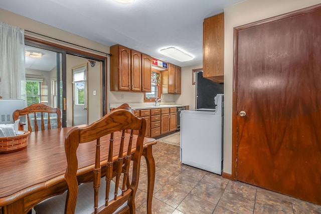 465 Ridge Rd, Quincy, MI 49082 - kitchen featuring stove, light countertops, brown cabinetry, and dishwashing machine