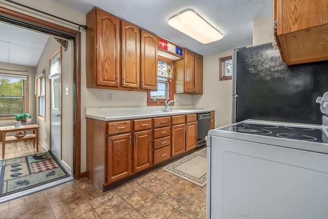 465 Ridge Rd, Quincy, MI 49082 - kitchen with white electric range oven, black dishwasher, freestanding refrigerator, and brown cabinets