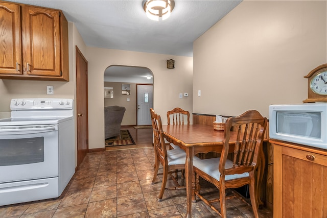 465 Ridge Rd, Quincy, MI 49082 - dining area with arched walkways and dark stone finish floors