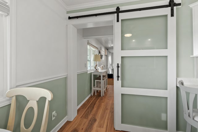 4150 Ridge Rd Unit 21And 22, Stevensville, MI 49127 - hallway featuring a barn door, ornamental molding, wood finished floors, and baseboards