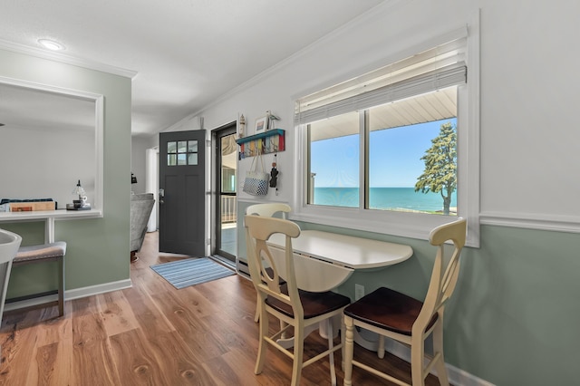 4150 Ridge Rd Unit 21And 22, Stevensville, MI 49127 - dining area featuring plenty of natural light, wood finished floors, ornamental molding, a water view, and baseboards