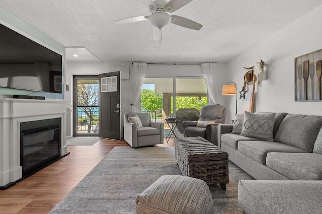 4150 Ridge Rd Unit 21And 22, Stevensville, MI 49127 - living room featuring a textured ceiling, ceiling fan, a glass covered fireplace, wood finished floors, and recessed lighting