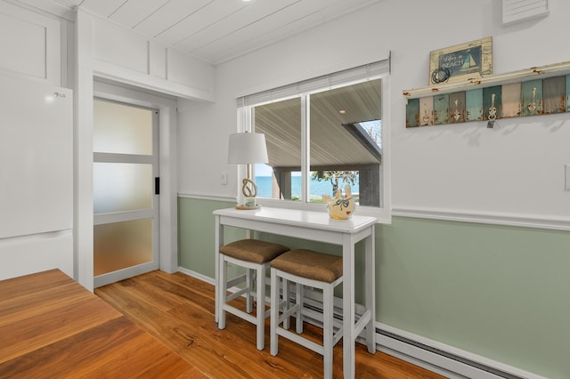 4150 Ridge Rd Unit 21And 22, Stevensville, MI 49127 - dining space with wood finished floors, a baseboard heating unit, and wooden ceiling