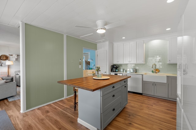 4150 Ridge Rd Unit 21And 22, Stevensville, MI 49127 - kitchen featuring gray cabinetry, wooden counters, dishwashing machine, a sink, and light wood-style flooring