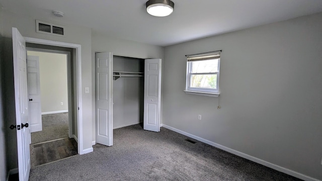 unfurnished bedroom with carpet floors, baseboards, and a closet