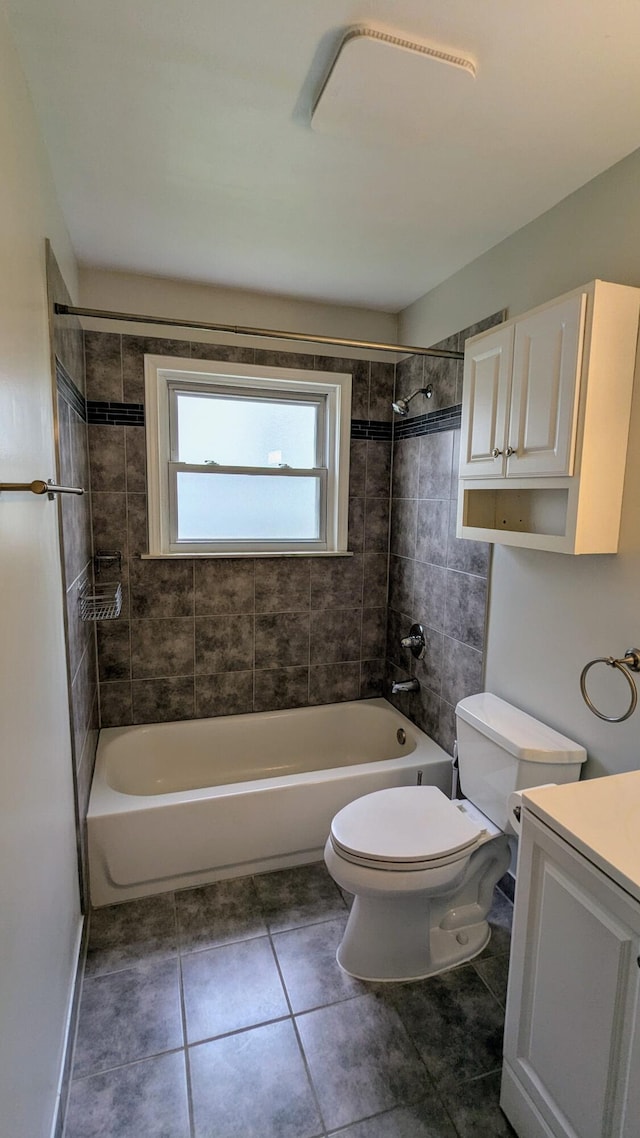 bathroom with toilet, tile patterned floors, washtub / shower combination, and vanity