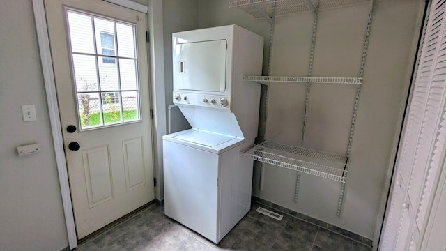 laundry room featuring stacked washer and clothes dryer