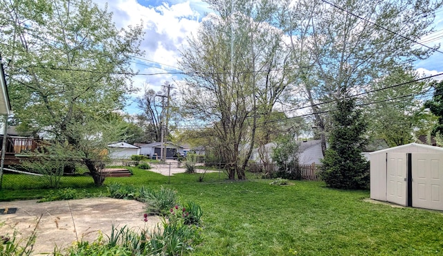 view of yard with a storage shed, an outdoor structure, and a patio