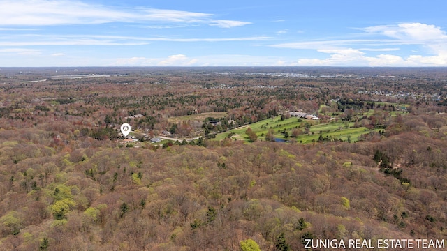 aerial overview of property's location with a heavily wooded area