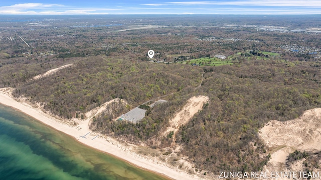 aerial overview of property's location featuring a heavily wooded area and expansive coastline