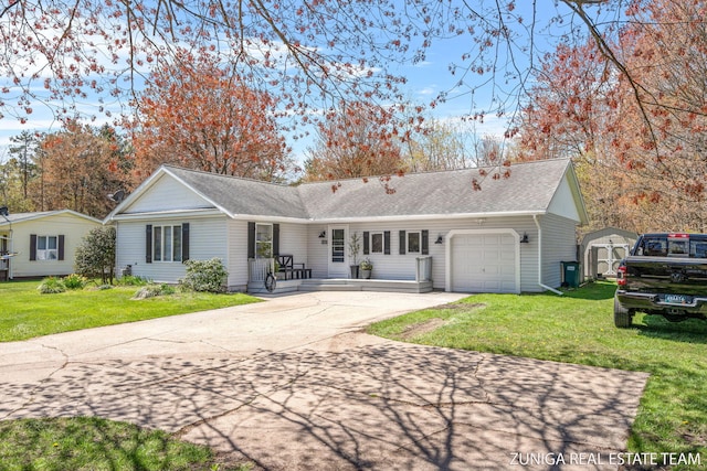 single story home with a storage unit, an attached garage, driveway, and a front yard
