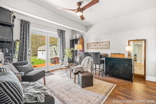 living room with a ceiling fan and wood finished floors
