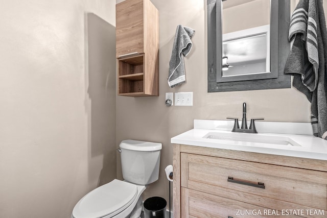 bathroom with toilet and vanity