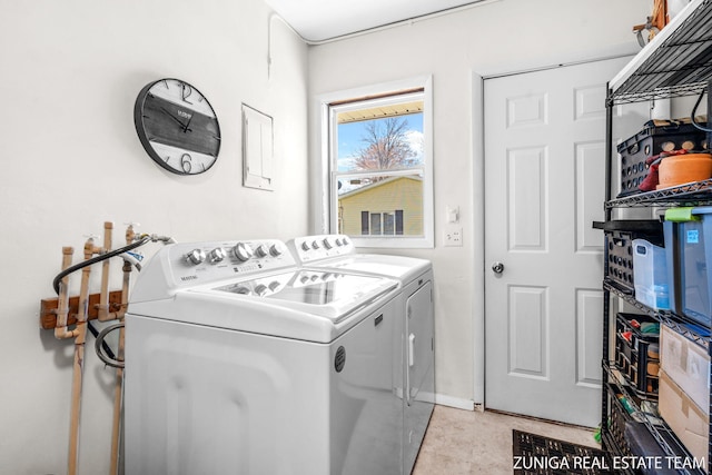 washroom featuring independent washer and dryer and baseboards