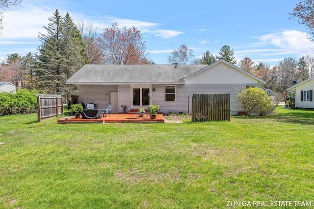 back of property featuring a wooden deck and roof with shingles