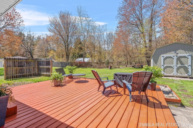 wooden deck with a shed and an outbuilding